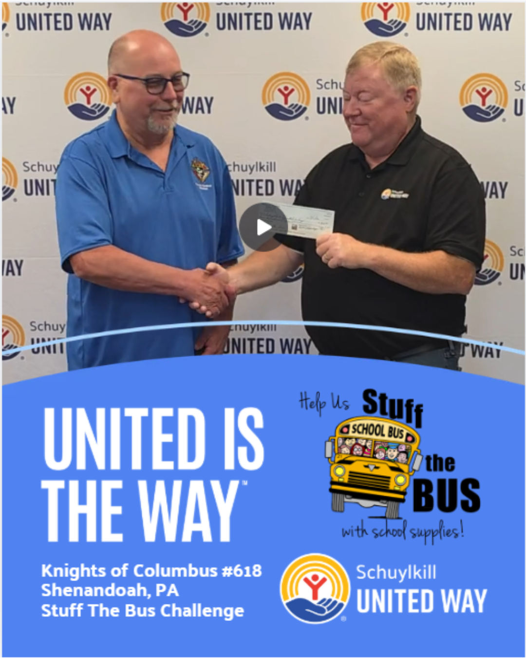 Bill Applegate of the Knights of Columbus is presenting a check to Mike Joyce of Schuylkill United Way. They are standing in front of an SUW back drop.